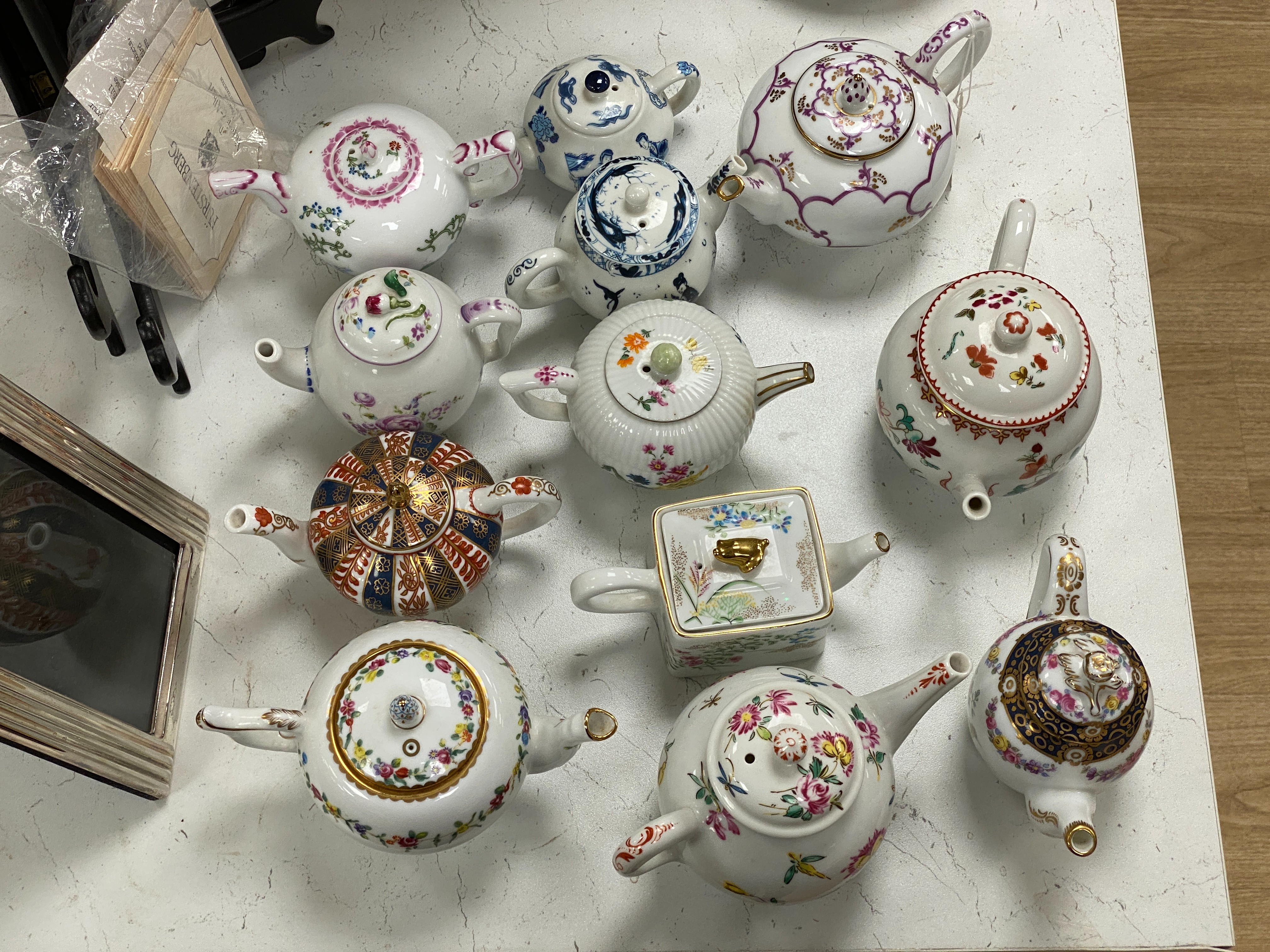 13 V&A collection and other miniature porcelain teapots.